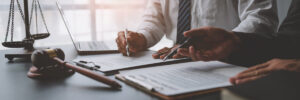 Businessmen or lawyers working together at a meeting, teamwork and partnership. Signing documents, contracts, checking details business agreement