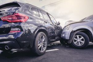 Car crash dangerous accident on the road. SUV car crashing beside another one on the road..
