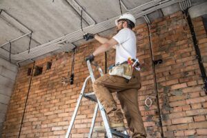Electrician with tools, working on a construction site. Repair and handyman concept.